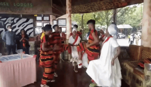 People Dancing In Front Of Rise Lodges Sign GIF