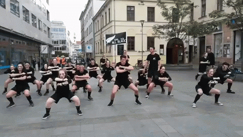 People Dancing in Front of Sign All in Black