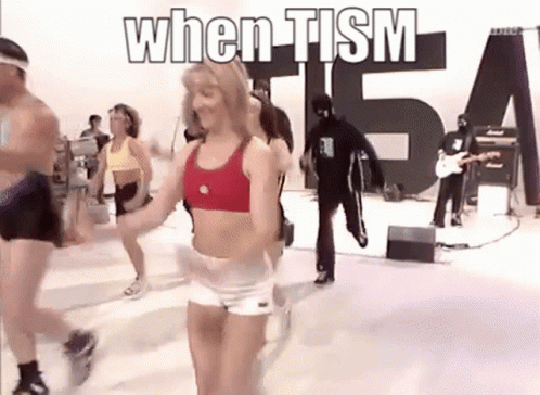 People Dancing in Front of When Tism Sign
