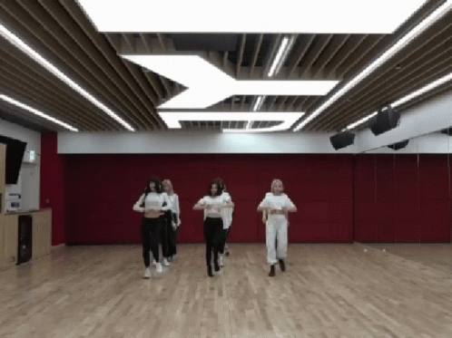 People Dancing in Room with Red Wall