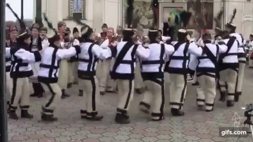 People Dancing in Traditional Costumes