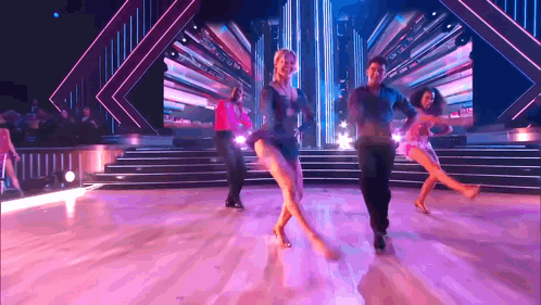 People Dancing on Stage Purple Background