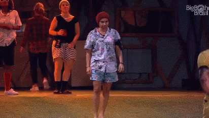 People Dancing on Stage with Big Brother Brasil Logo