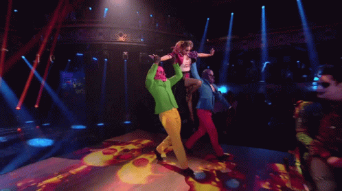 People Dancing On Stage With Green Jacket GIF