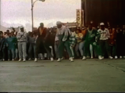 People Dancing on Street in Front of Building
