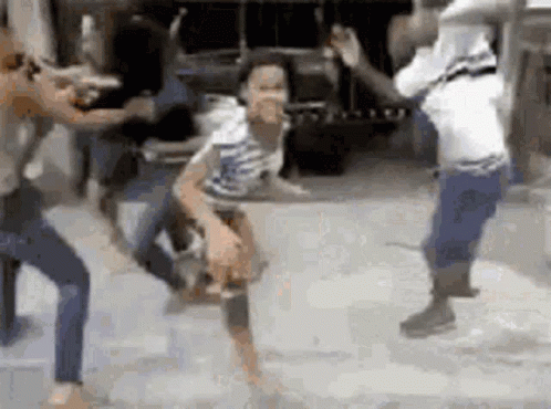 People Dancing on Street in Front of Truck