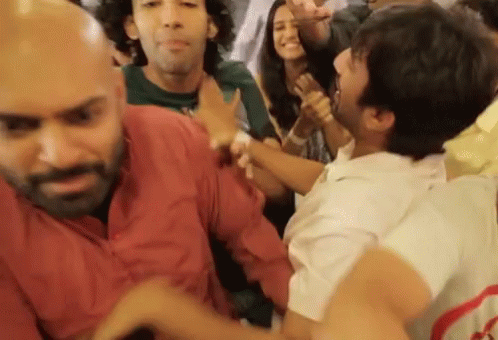 People Dancing With Man Holding Another's Arm