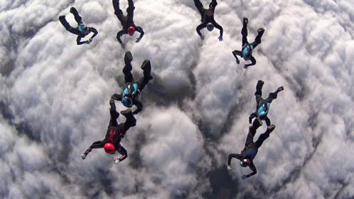 People Flying, One in Red Helmet