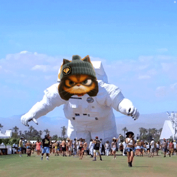 People Gathered Around Inflatable Astronaut Cat GIF