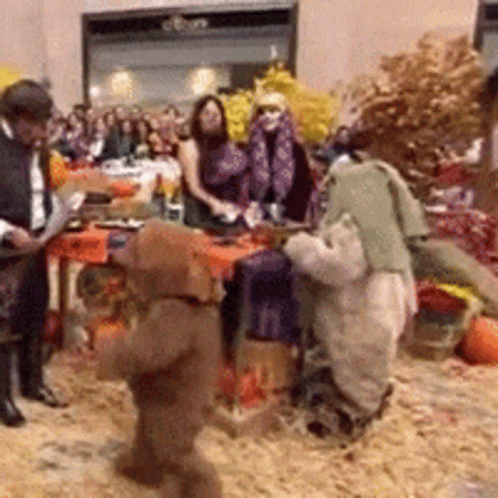 People Gathered Around Table With Stuffed Animals