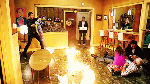 People Gathered in Living Room with Fire