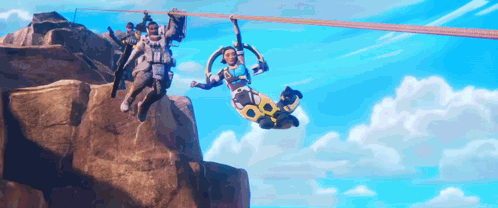 People Hanging From Rope Over Mountain