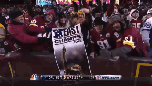People Holding Sign Saying 40 In East Champ GIF
