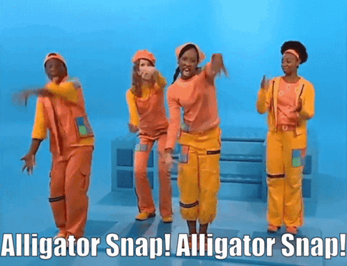 People in Orange and Yellow Jumpsuits Dancing With Alligator Snap