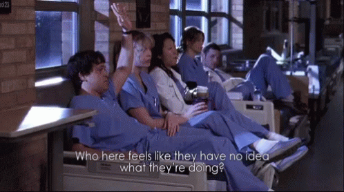 People in Scrubs Sitting in Chairs