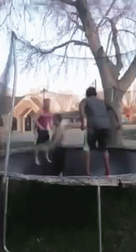 People Jumping On Trampoline In Front Of House GIF