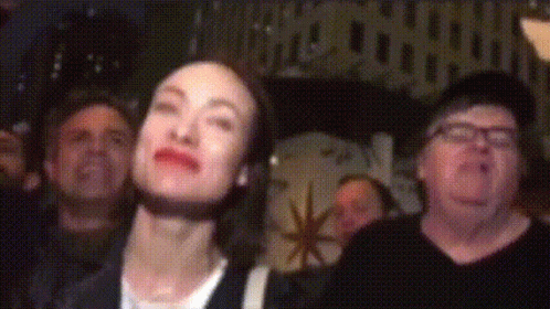 People Looking Up in Dark Room