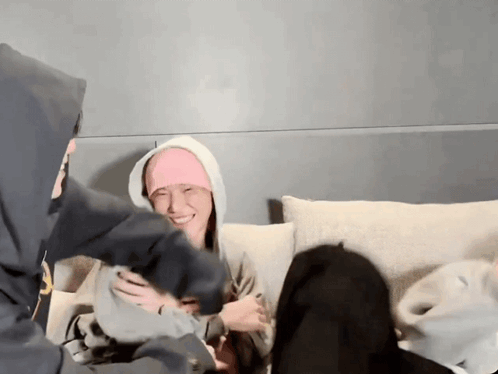 People on Couch, One in Pink Headband
