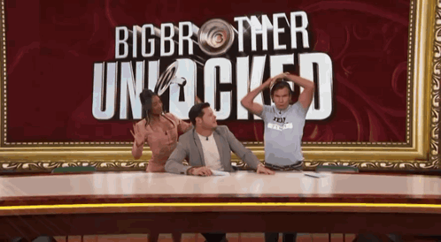 People on Stage in Front of Big Brother Unlocked Sign