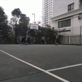 People Playing Basketball Near Building