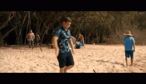 People Playing Frisbee on Beach