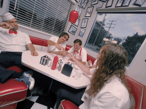 People Playing Rock Paper Scissors In Restaurant GIF