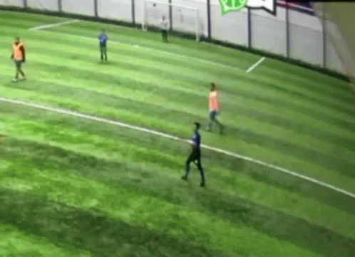 People Playing Soccer on Green Field