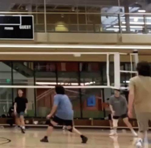 People Playing Volleyball in Gym