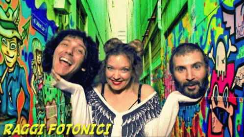 People Posing at Graffiti Wall Raggi Fotonici