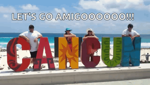 People Posing In Front Of Cancun Sign GIF