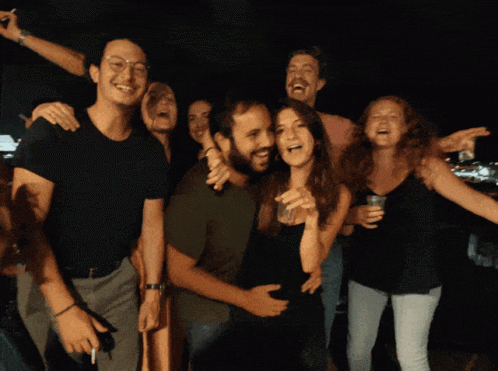 People Posing With Woman Holding Glass GIF