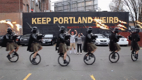 People Riding Bicycles Past Keep Portland Weird Sign