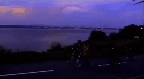 People Riding Bikes on Road Near Water