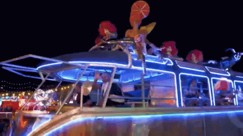 People Riding Lit Up Boat at Night