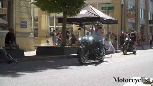 People Riding Motorcycles on Street With Motorcyclist Text