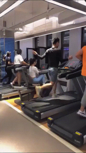 People Running On Treadmills In Gym GIF