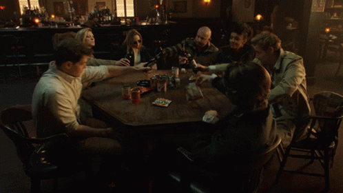 People Sitting Around Table in Dark Room
