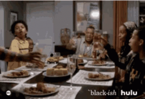 People Sitting Around Table With Food And Wine GIF