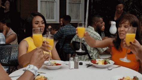 People Sitting at Table with Orange Juice