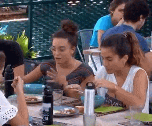 People Sitting at Table with Plates of Food