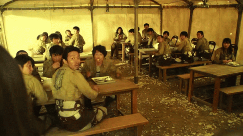 People Sitting At Tables Under Tent Eating GIF