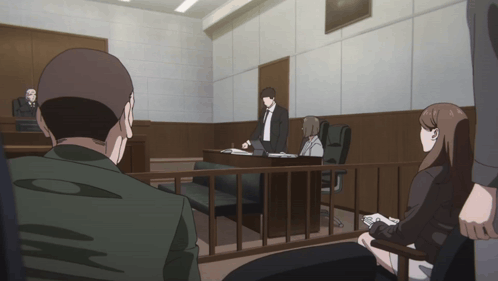 People Sitting In Courtroom Behind Fence GIF
