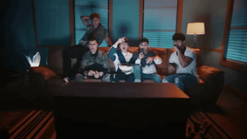 People Sitting On Couch Watching TV GIF