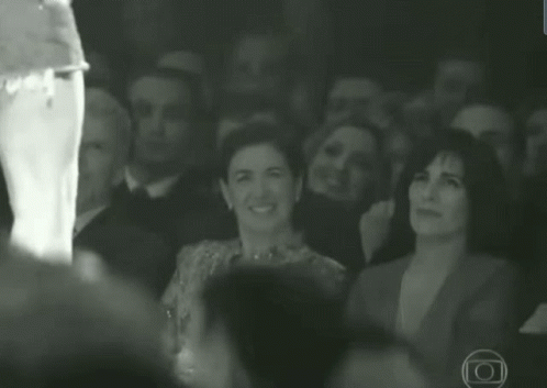 People Smiling in Dark Room