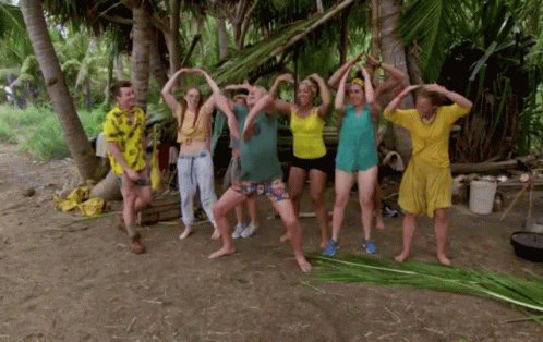 People Standing in Circle With Hands Up