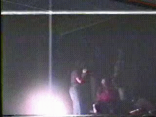 People Standing In Dark Room GIF