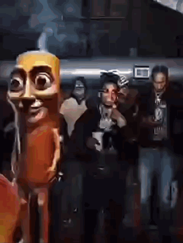 People Standing in Dark Room with Cartoon Character