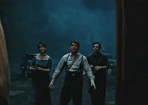 People Standing in Dark Room with Lantern