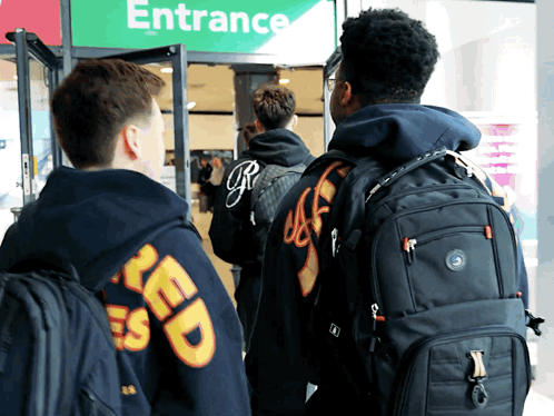 People Standing in Front of Entrance Sign