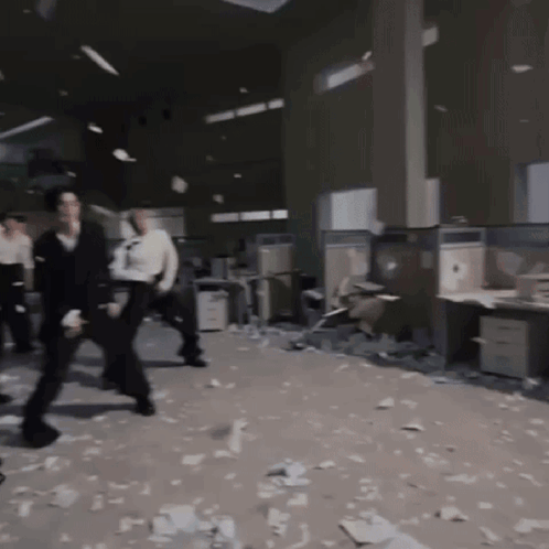 People Standing in Messy Office